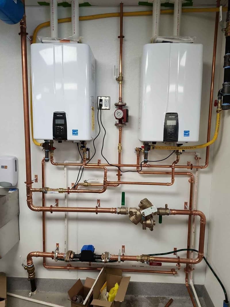 Two tankless water heaters with copper piping